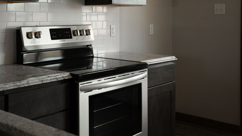 An oven in a kitchen with granite countertops